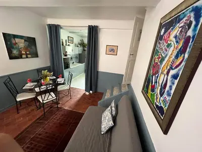 a living room with a table and a dining room at Duplex proche mer, avec swimspa terrasse, jardin et barbecue in Lapalme