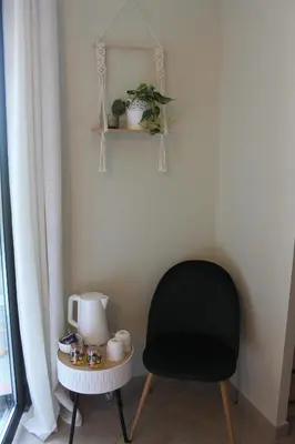 a black chair and a table in a room at La Naillousaine in Nailloux