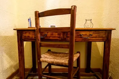 a wooden desk with a chair in a room at La Maison Bleue in Oupia