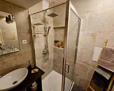 a bathroom with a shower and a sink at La Maison Bleue in Oupia