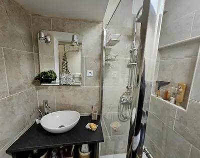 a bathroom with a sink and a shower at La Maison Bleue in Oupia