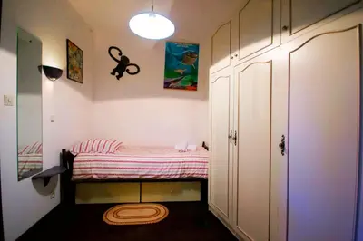 a small room with a small bed in it at La Maison Bleue in Oupia