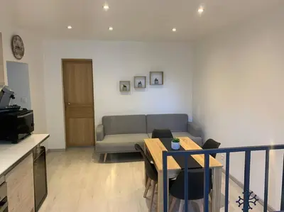 a living room with a couch and a table at Location de vacances à Quarante Gîte de la cave Szymczak in Quarante