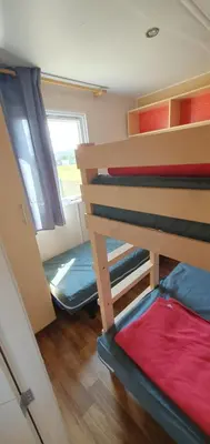 a room with two bunk beds and a window at MH135 camping NOVELA - location entre particuliers- Mobil home 5pl climatisé - in Port-la-Nouvelle