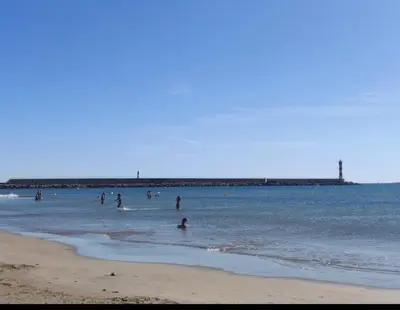 a group of people in the water at the beach at Mobil home de Patricia et Franck à Sigean in Sigean
