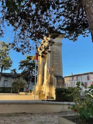a large monument in front of a building at Rue Basse - village house overlooking the Pyrenees in Montréal