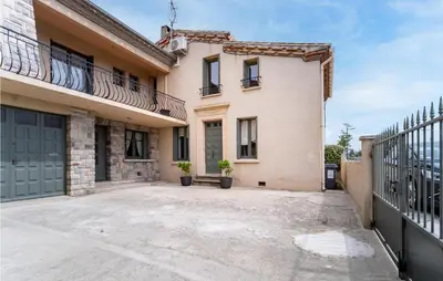 an empty parking lot in front of a house at Beautiful Home In Villegly With Kitchen in Villegly