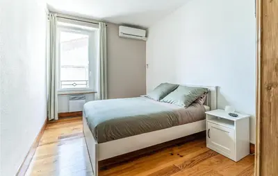a small bedroom with a bed and a window at Beautiful Home In Villegly With Kitchen in Villegly