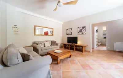 a living room with two couches and a tv at Beautiful Home In Villegly With Kitchen in Villegly