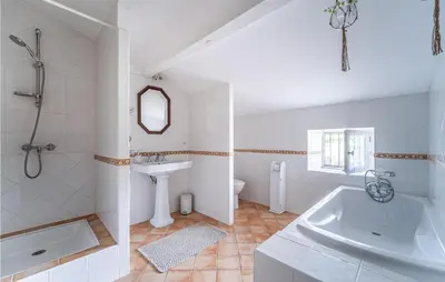 a white bathroom with a sink and a tub at Beautiful Home In Villegly With Kitchen in Villegly