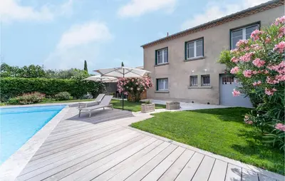 a backyard with a swimming pool and a house at Beautiful Home In Villegly With Kitchen in Villegly