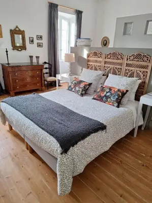 a bedroom with a large bed with pillows at domaine de Capoulade in Narbonne