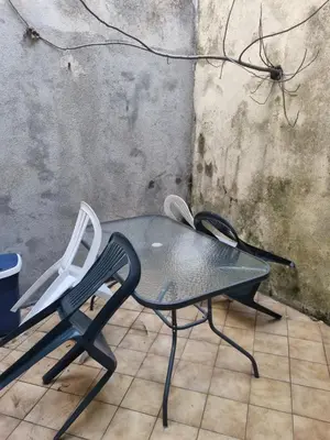 a black table and a white chair in a room at Gîte de la confluence in Padern