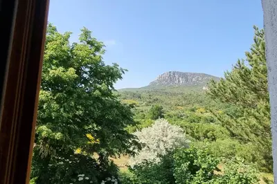 a view of a mountain from a window at Gîte de la confluence in Padern