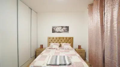 a small bedroom with a bed with at Appartement Les Halles 2, Climatisation, Terrasse, Garage in Narbonne