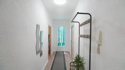 a hallway of a house with a plant in it at Appartement Les Halles 2, Climatisation, Terrasse, Garage in Narbonne