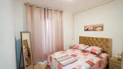 a bedroom with a bed with a mirror next to it at Appartement Les Halles 2, Climatisation, Terrasse, Garage in Narbonne