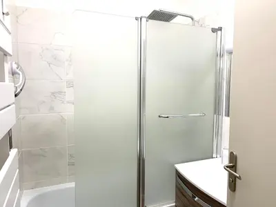 a shower with a glass door in a bathroom at Appartement Les Halles 2, Climatisation, Terrasse, Garage in Narbonne