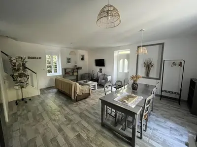 a living room with a table and a couch at la Tour du Grand DUC in Cenne-Monestiès