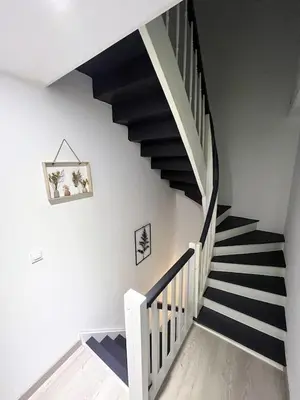 a staircase with black and white stripes in a house at la Tour du Grand DUC in Cenne-Monestiès