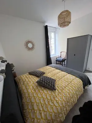 a bedroom with a bed with two pillows on it at la Tour du Grand DUC in Cenne-Monestiès