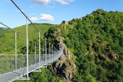 a suspension bridge on the side of a mountain at Villa 140 m² hab. avec piscine in Castres