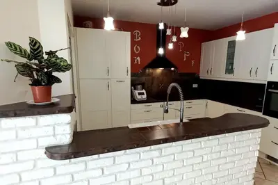 a kitchen with white cabinets and a sink at Villa 140 m² hab. avec piscine in Castres