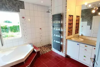 a bathroom with a tub and a sink at Villa 140 m² hab. avec piscine in Castres
