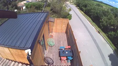a small house with a deck with chairs on it at studio des lices Villesequelande in Villesequelande