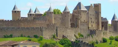 a large castle with turrets on top of a hill at studio des lices Villesequelande in Villesequelande