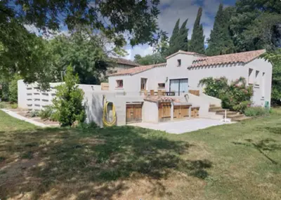 an exterior view of a house with a yard at Lodge with private pool surrounded by vineyards in Azille