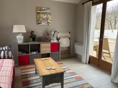 a living room with a table and a couch at Lodge with private pool surrounded by vineyards in Azille