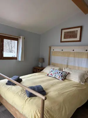 a bedroom with a large bed with two pillows on it at Lodge with private pool surrounded by vineyards in Azille