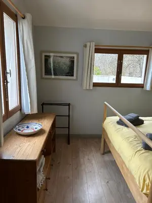 a room with a bed and a table and windows at Lodge with private pool surrounded by vineyards in Azille
