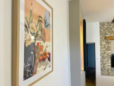 a painting hanging on a wall in a hallway at L'intemporel - Grand T2 Confort en Hypercentre in Castres