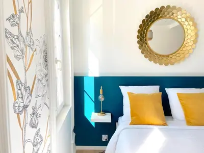 a blue and white bedroom with a bed and a mirror at L'intemporel - Grand T2 Confort en Hypercentre in Castres