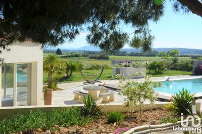 a house with a pool and a hammock in a yard at Domaine Ô Lingot d'Oc in Roubia