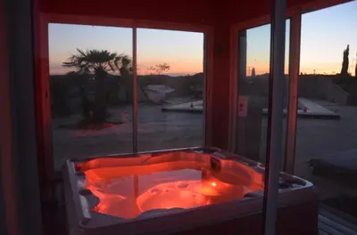 a red bath tub in a room with a window at Domaine Ô Lingot d'Oc in Roubia