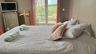 a bedroom with a bed with pillows and a window at Domaine Ô Lingot d'Oc in Roubia