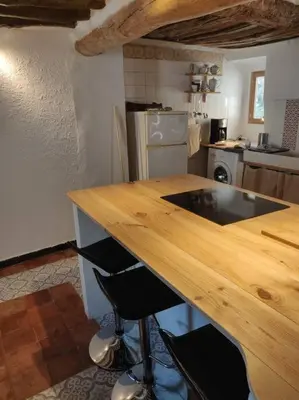 a kitchen with a wooden counter top in a kitchen at VILLA VILATA A PADERN DANS LES CORBIÈRES SAUVAGES in Padern