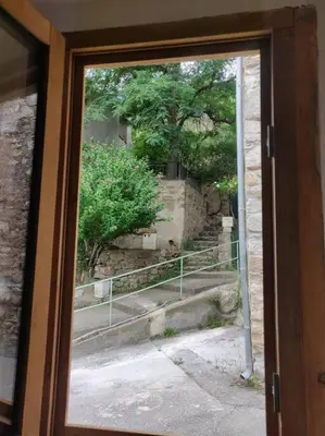 a view through a glass door of a stairway at VILLA VILATA A PADERN DANS LES CORBIÈRES SAUVAGES in Padern