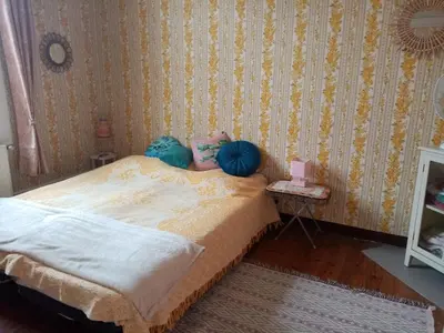 a bedroom with a bed with two blue balls on it at Les Toiles du Figuier in Espéraza