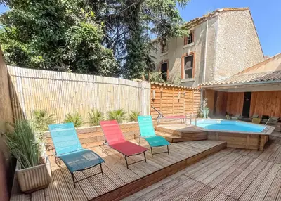 a deck with four chairs and a swimming pool at Superbe Villa avec piscine, 4 chambres à Vinassan in Vinassan