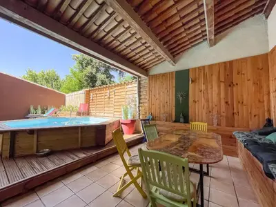 a patio with a hot tub and a table and chairs at Superbe Villa avec piscine, 4 chambres à Vinassan in Vinassan