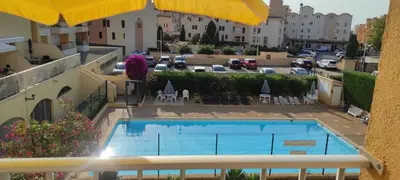 a view of a swimming pool on a balcony at Petit appart sympa clim piscine balcon in Gruissan