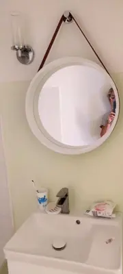 a bathroom with a mirror above a white toilet at Petit appart sympa clim piscine balcon in Gruissan