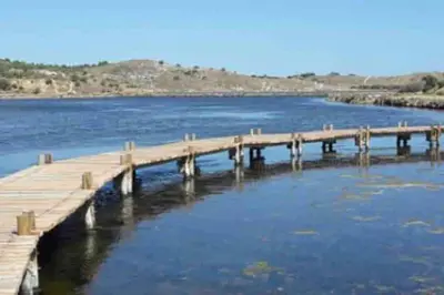 a dock in the middle of a body of water at Le colibri in Lapalme