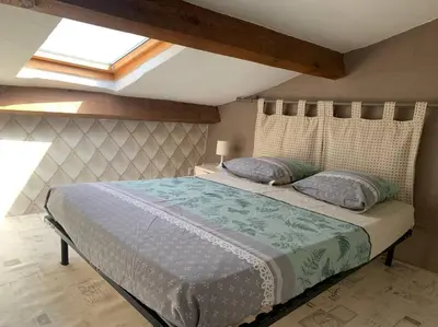a bedroom with a large bed with two pillows at Le colibri in Lapalme