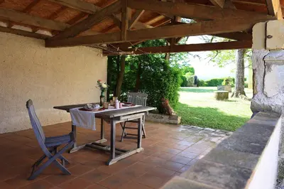 a table and chairs sitting on a patio at Gites de Labadie in Lautrec