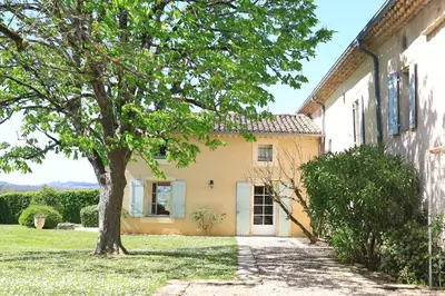 an exterior view of a house with a tree at Gites de Labadie in Lautrec